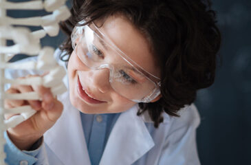 gifted elementary student studying a piece of DNA