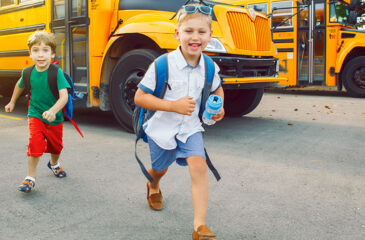 two kids running from bus