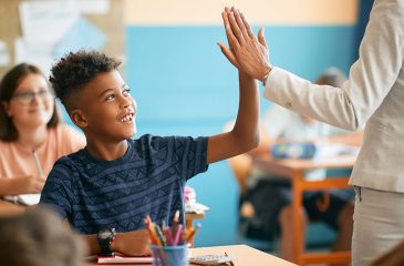 student and teacher high five