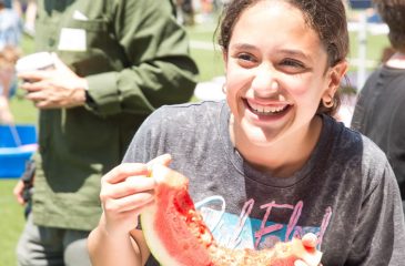 girl eating watermelon at PTA carnival